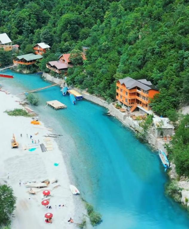 Aerial view of Shala River with turquoise waters and riverside restaurants